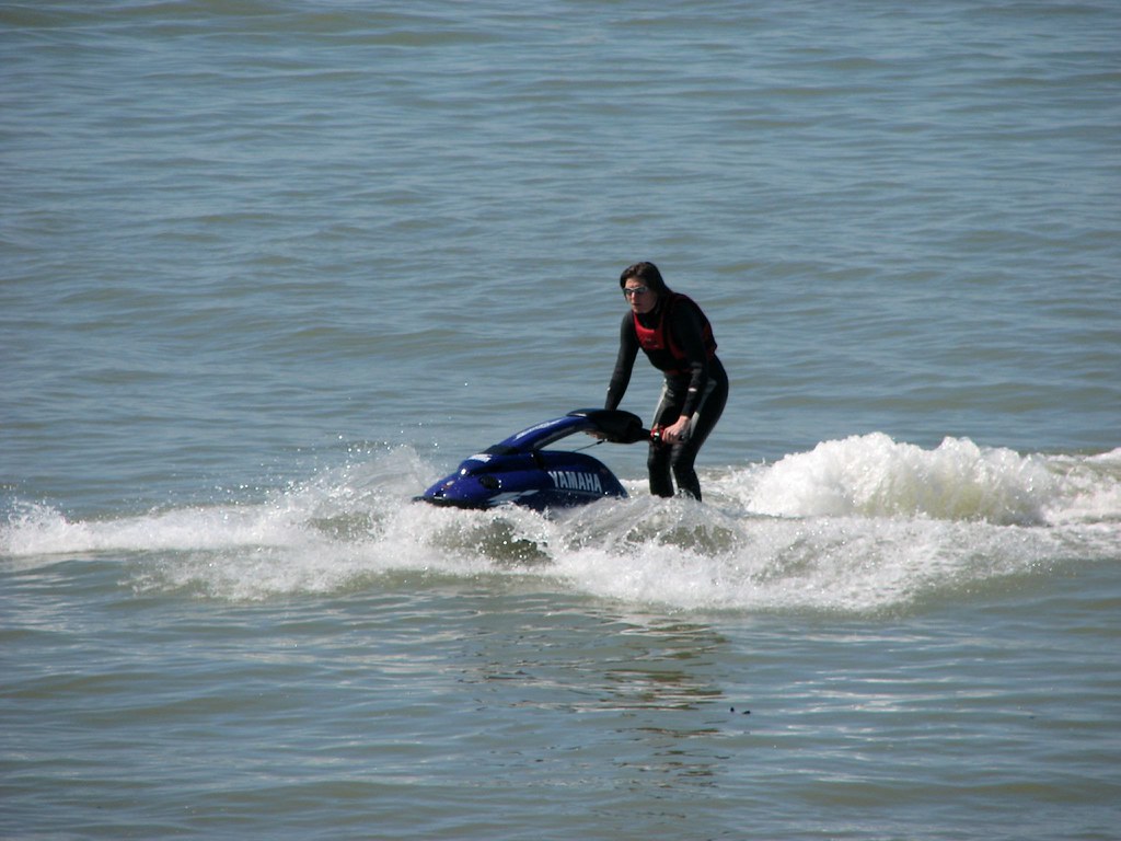 Woman riding a stand-up jet ski in a lake