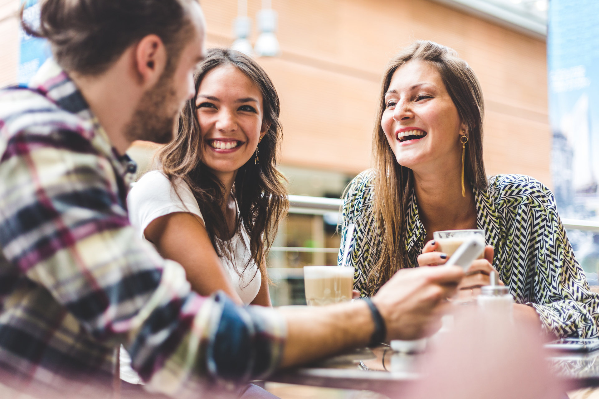 Two girls and guy socializing over a day during the day