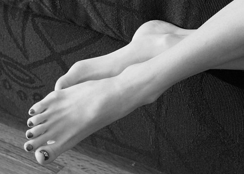 Close of view of a females slim and attractive feet and ankles.