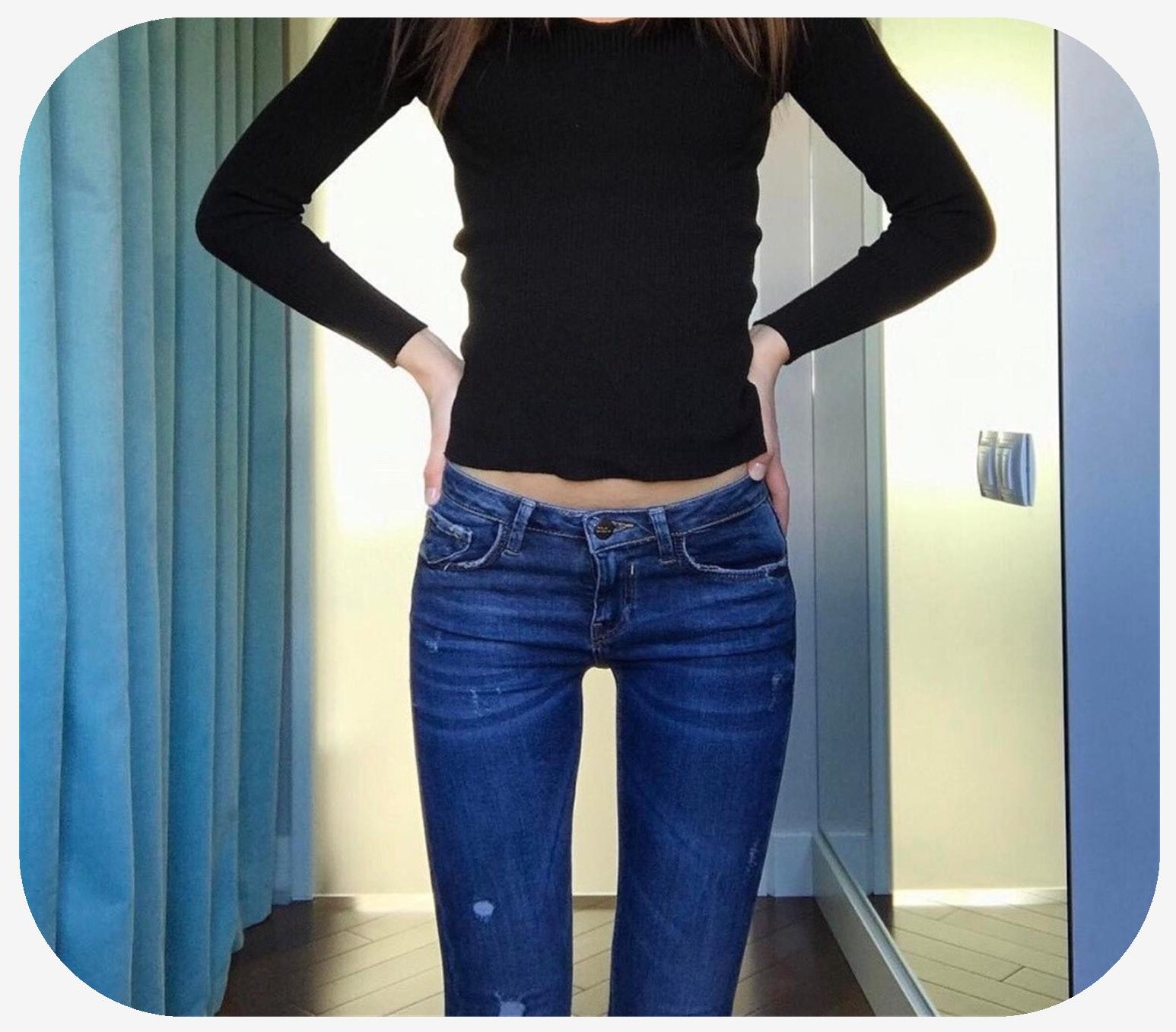 Slim female standing with hands at her hips