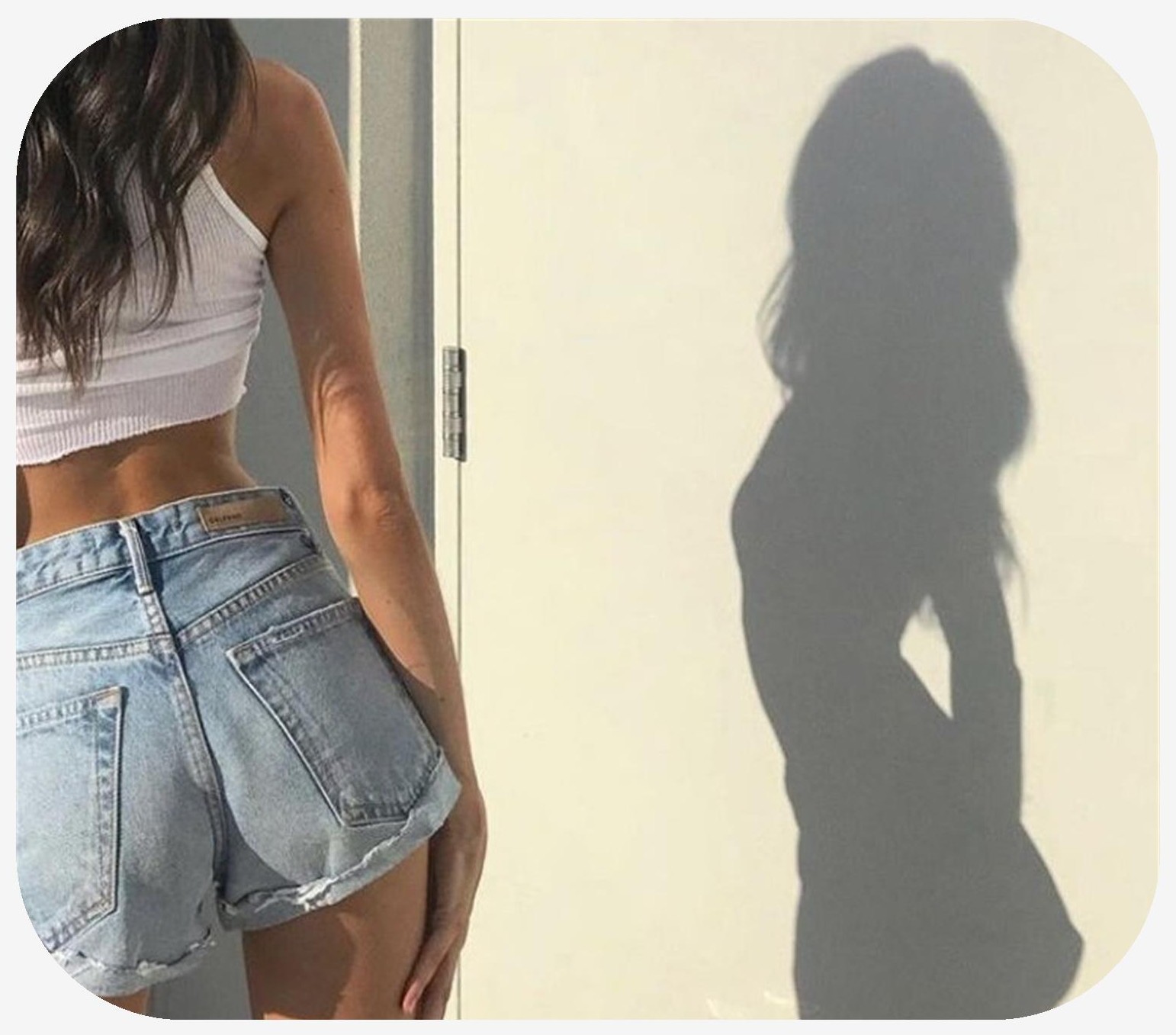 Woman standing in daylight in a skirt with an attractive shadow on the wall