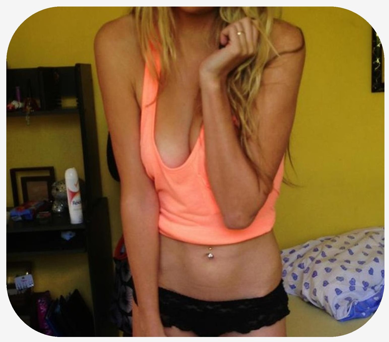 Female wearing a tank top in which large areola outlines are visible through clothing