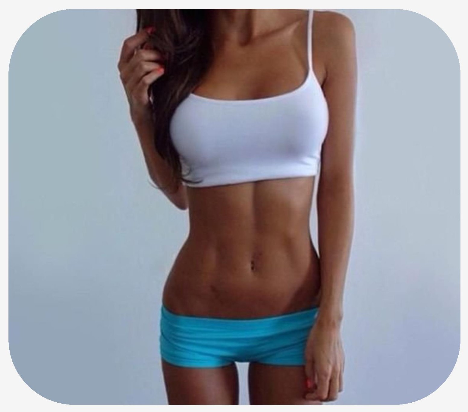 Skinny female with large breasts who is bearing booty shorts and a tank top who has an amazing body