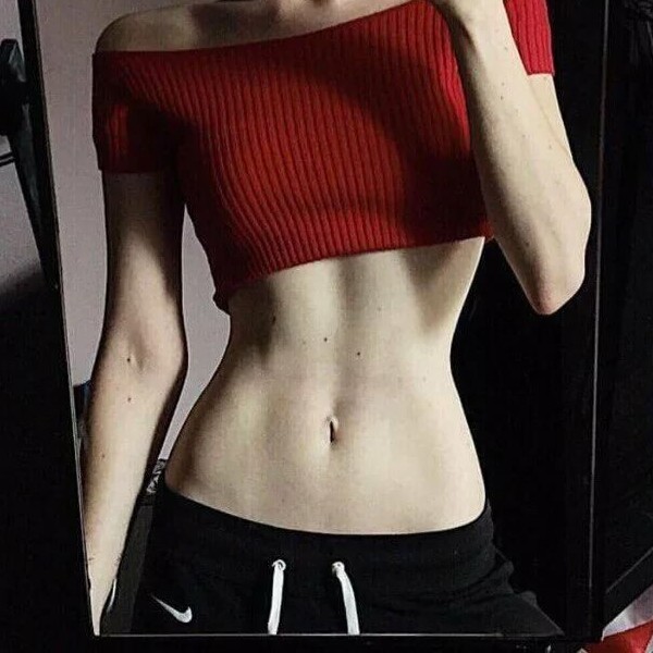 Front view of woman standing who has an hourglass figure.