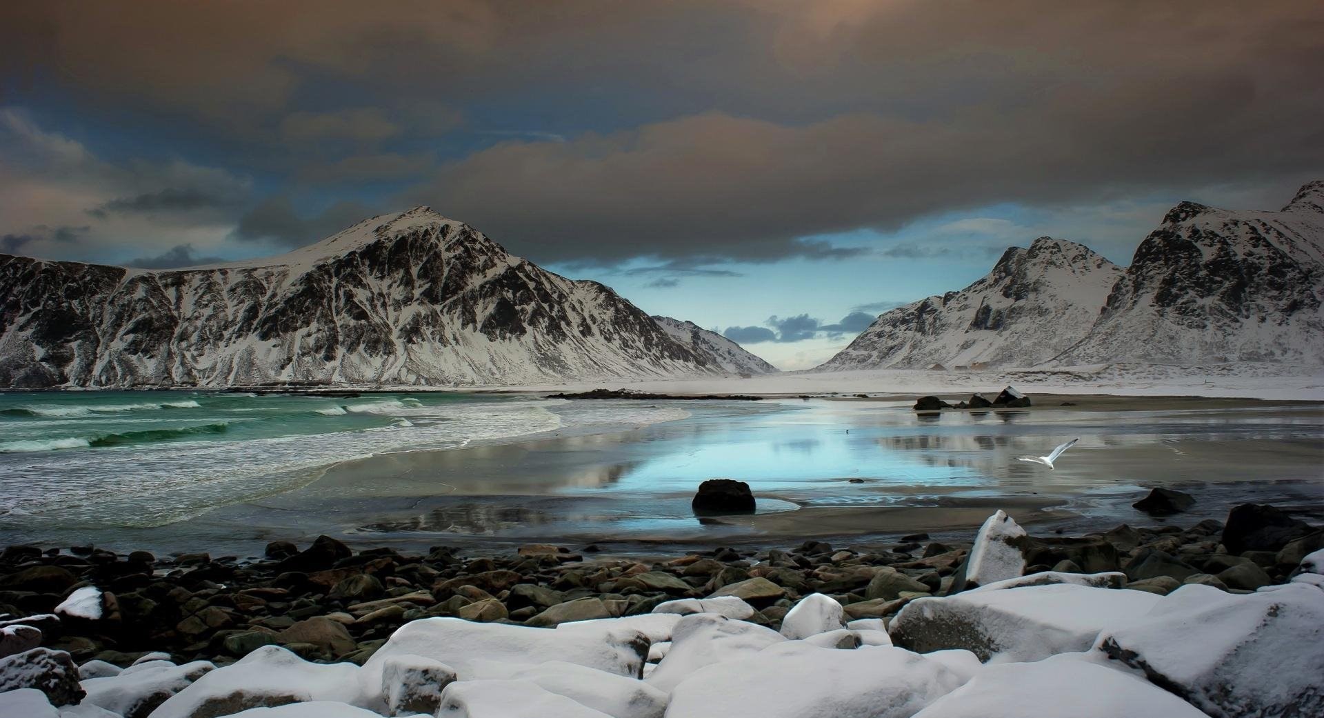 Snowy valley in the mountains with purple sky