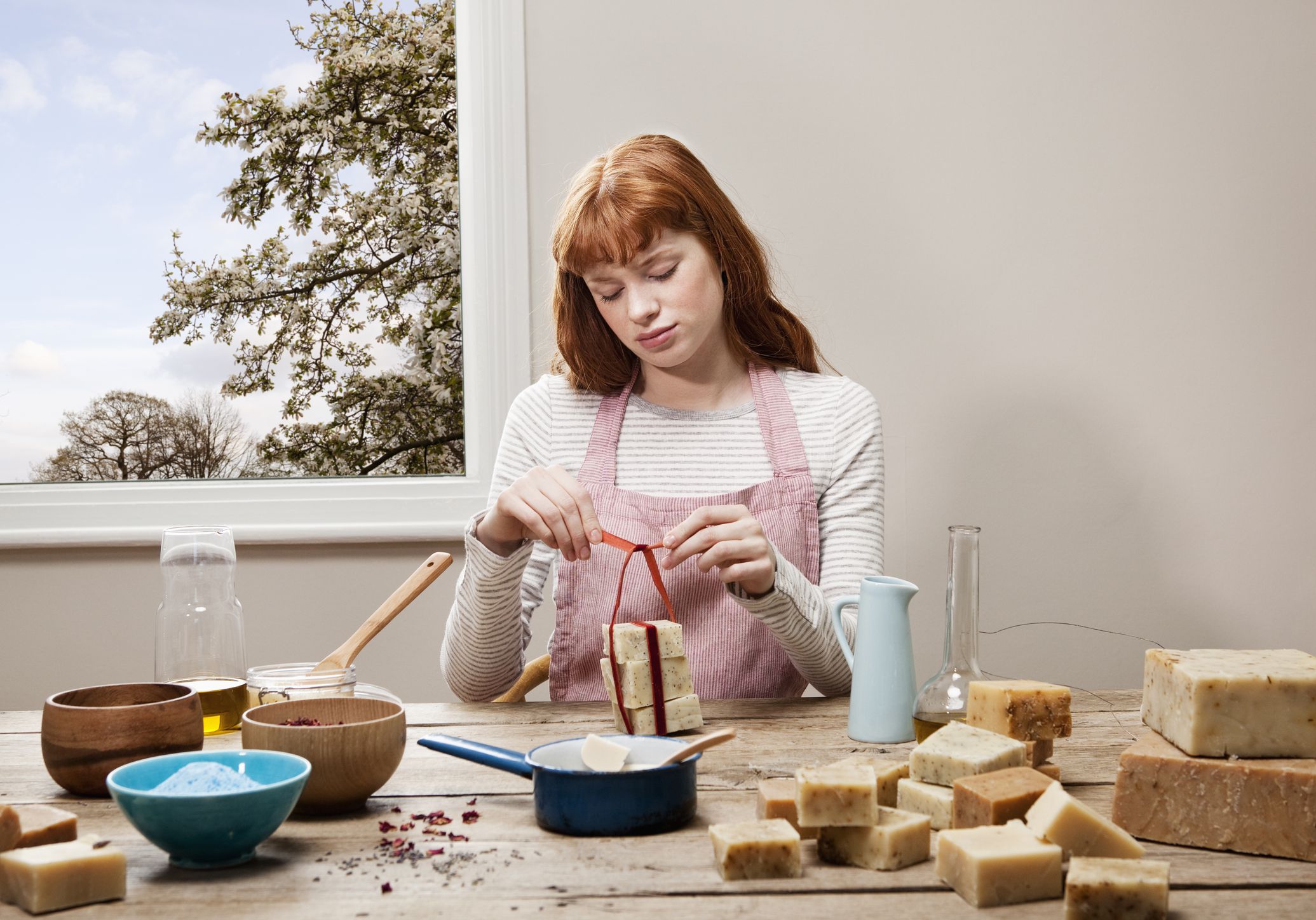 Woman sitting down who is making soap