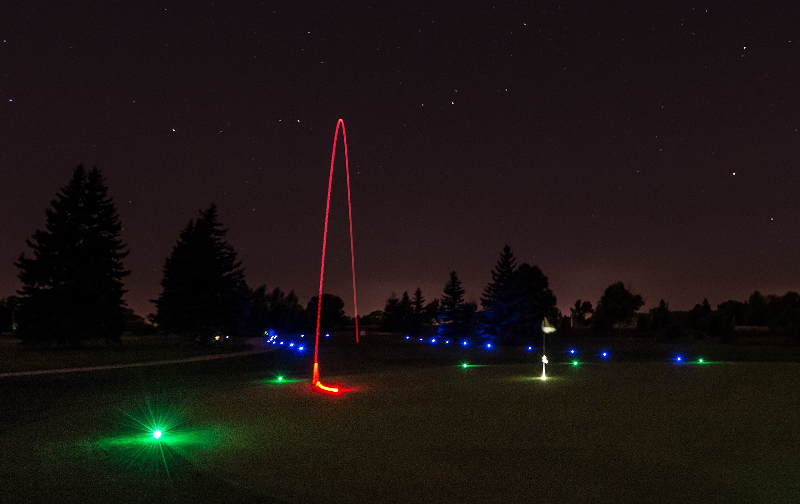 Person golfing at night